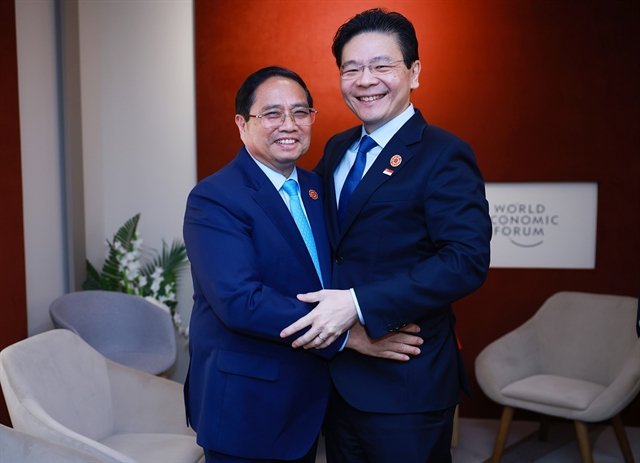 Vietnamese Prime Minister Phạm Minh Chính (left) and Singaporean counterpart Lawrence Wong had talks in China on June 25 on the sidelines of the WEF meeting
